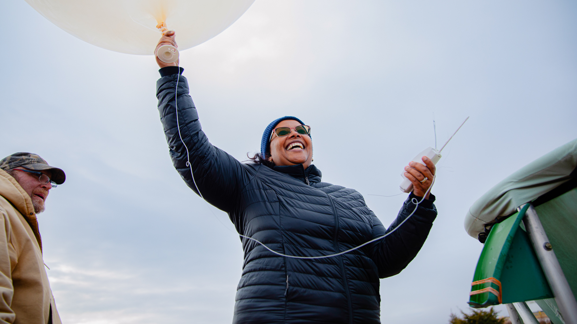 DOE Office of Science Director Asmeret Asefaw Berhe holds onto a large weather balloon.