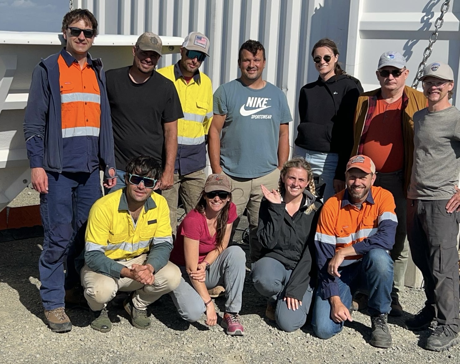 ARM team members gather in front of ARM instruments and containers for a group picture during the CAPE-k installation in Tasmania.