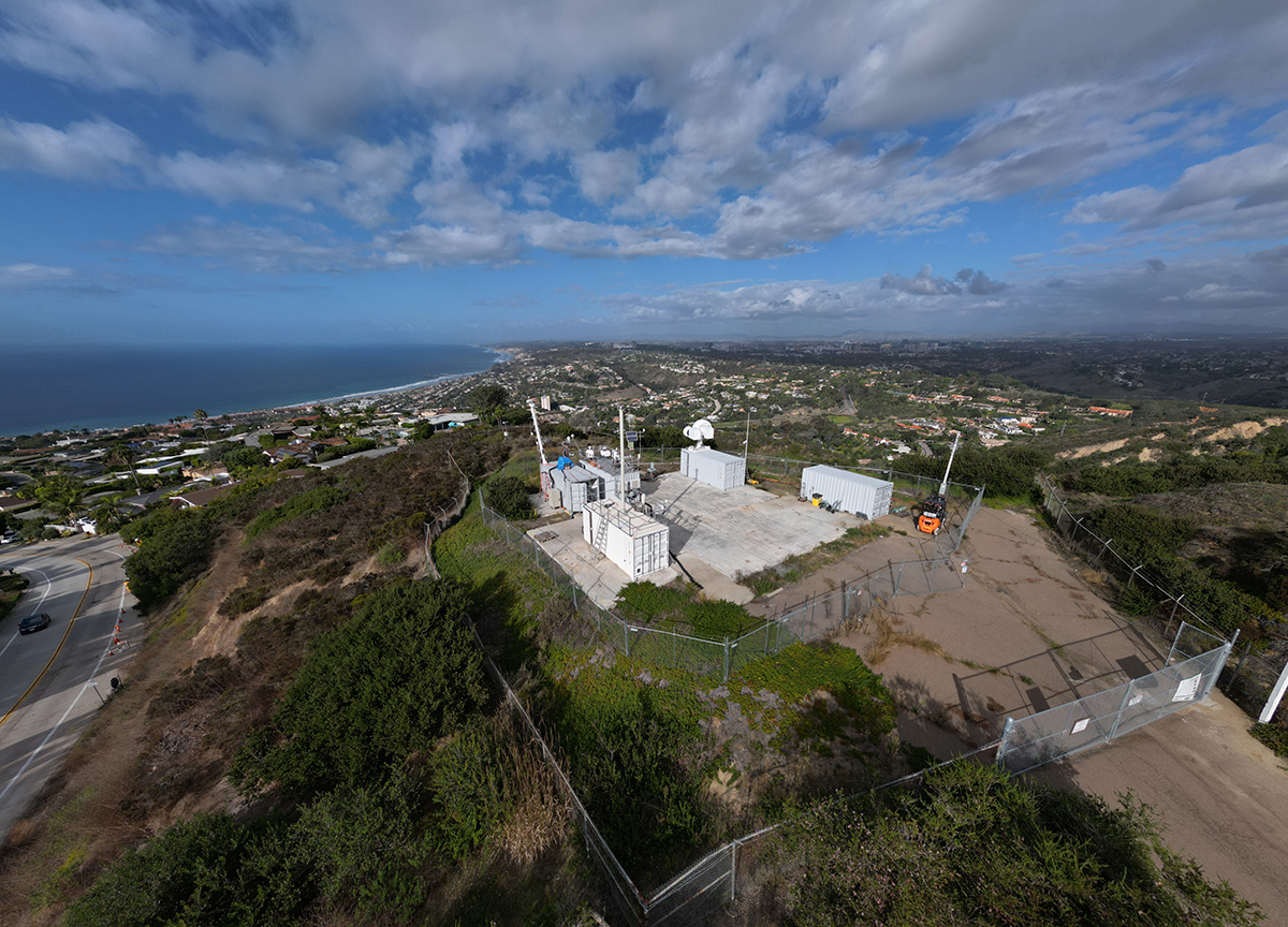 In La Jolla, California, clouds streak across the sky while ARM radars, guest instruments, and containers on Mount Soledad overlook the nearby area, including the Pacific Ocean, during the EPCAPE campaign.