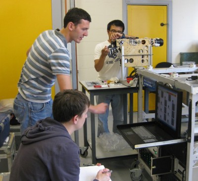 wisc2009-161-low In a laboratory at the University of Manchester, scientists run an experiment using a micromanipulator to test the depth-of-field of the Cloud Particle Imager. Researchers (front to back) include Chris Emersic and Paul Connolly from the University of Manchester, and Junshik Um from the University of Illinois. ARM file photo.